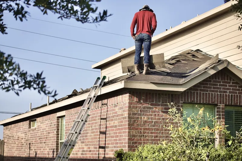 Professional roofer working on a residential roof in Muttonville